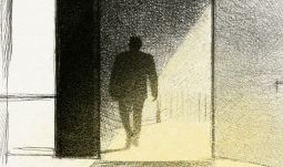 a man carrying a small bag walking into a well lit office 