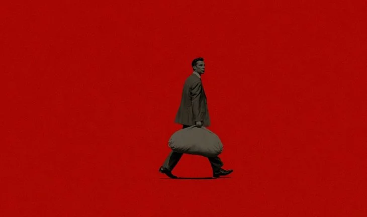 banker carrying a bag of money against a red background