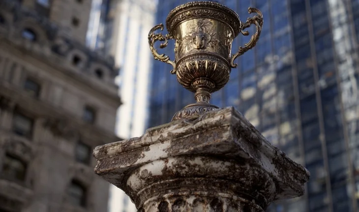 a winner's cup on a corroded post 