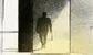 a man carrying a small bag walking into a well lit office 